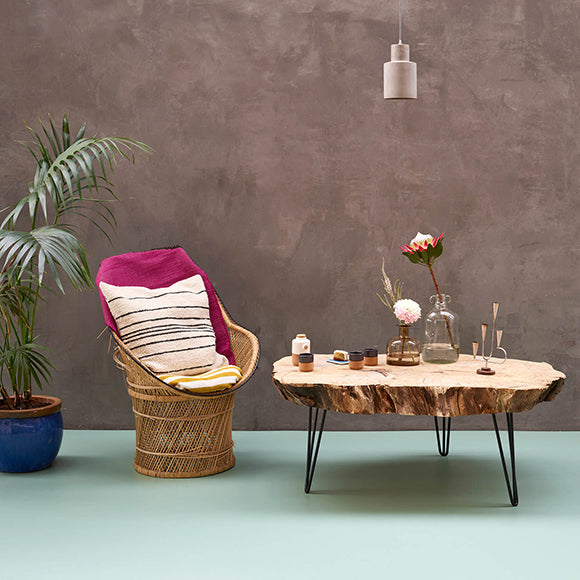 Pistachio green sheet vinyl flooring with wicker chair and wooden table